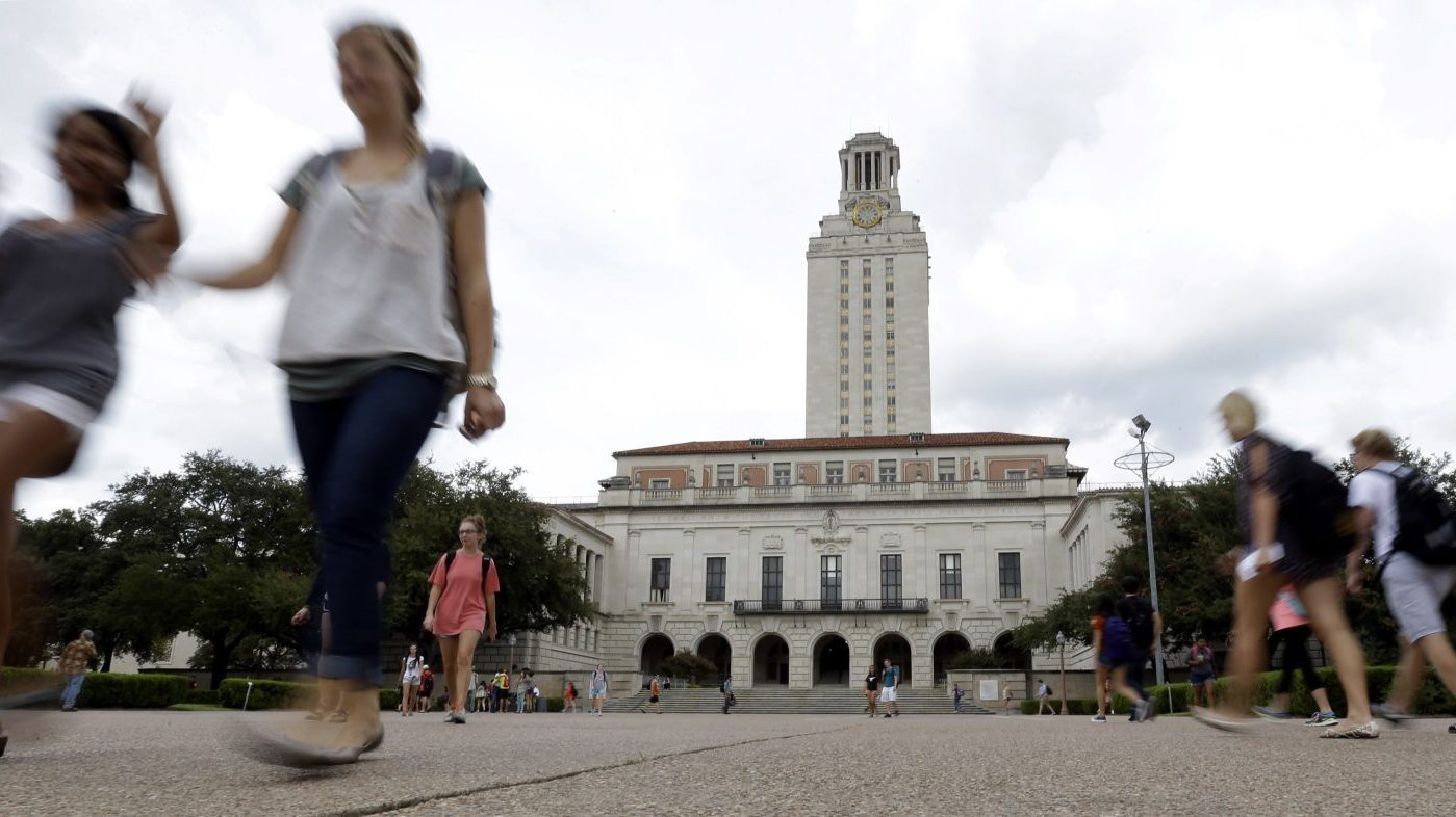 Students walk through the University of Texas at Austin campus near the school’s iconic tower, Sept. 27, 2012, in Austin, Texas.