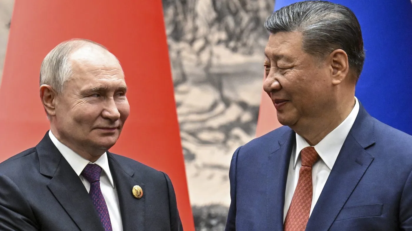 Chinese President Xi Jinping, right, and Russian President Vladimir Putin look toward each other as they shake hands prior to their talks in Beijing, China, on Thursday, May 16, 2024. (Sergei Bobylev, Sputnik, Kremlin Pool Photo via AP)