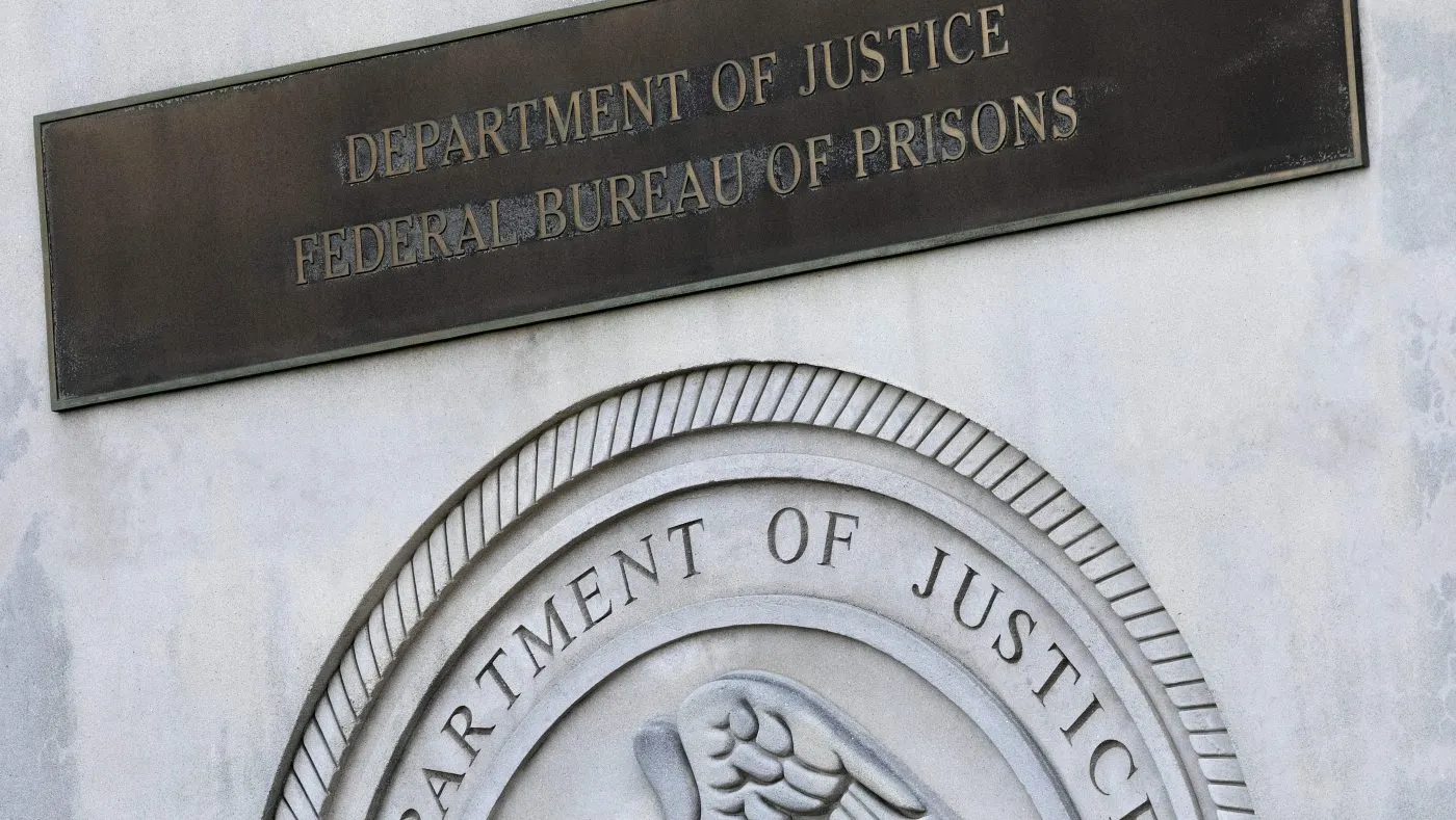 FILE – A sign for the Department of Justice Federal Bureau of Prisons is displayed in the Brooklyn borough of New York, July 6, 2020. (AP Photo/Mark Lennihan, File)
