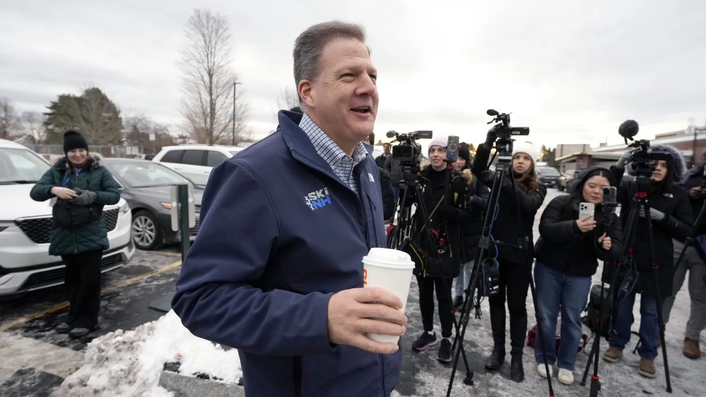 New Hampshire Gov. Chris Sununu walks past members of the media while greeting people, Tuesday, Jan. 23, 2024, near a polling site at Winnacunnet High School in Hampton, N.H. (AP Photo/Steven Senne)
