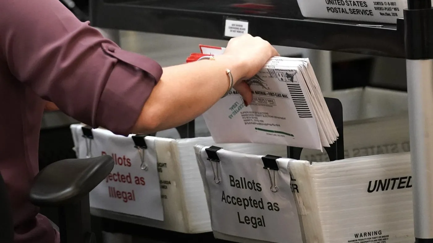 An election worker sorts vote-by-mail ballots at the Miami-Dade County Board of Elections on Oct. 26, 2020, in Doral, Fla. (AP Photo/Lynne Sladky, File)