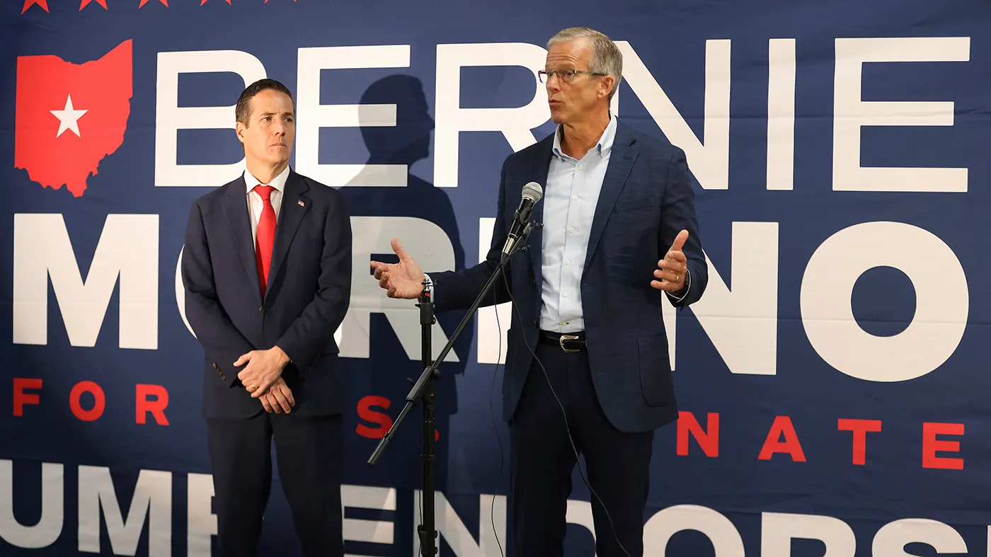 Ohio Republican Senate candidate Bernie Moreno, left, listens to Sen. John Thune (R-S.D.) speak during a bus tour stop for the Ohio Senate race in Columbus, Ohio, Oct. 28, 2024.
