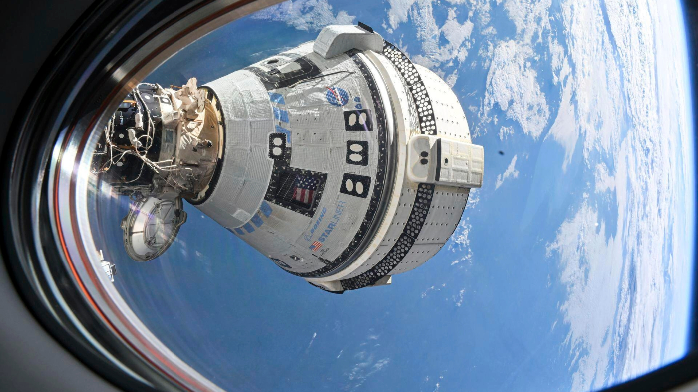 Boeing’s Starliner spacecraft, which launched astronauts Butch Wilmore and Suni Williams to the International Space Station, docked to the Harmony module’s forward port on July 3, 2024, seen from a window on the SpaceX Dragon Endeavour spacecraft docked to the adjacent port.