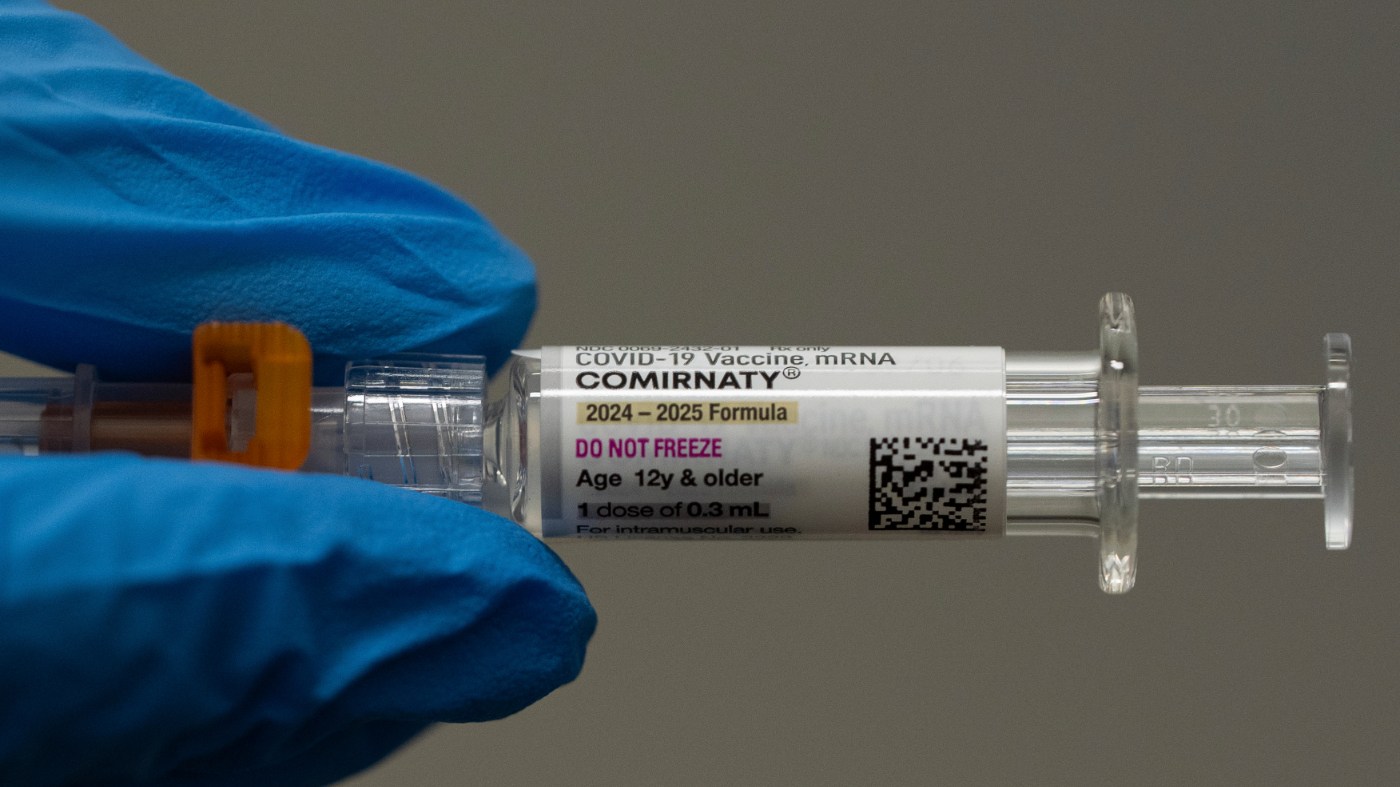 A pharmacist holds a Pfizer and BioNTech COVID-19 vaccine shot on April 24, 2025, in Portland, Ore.