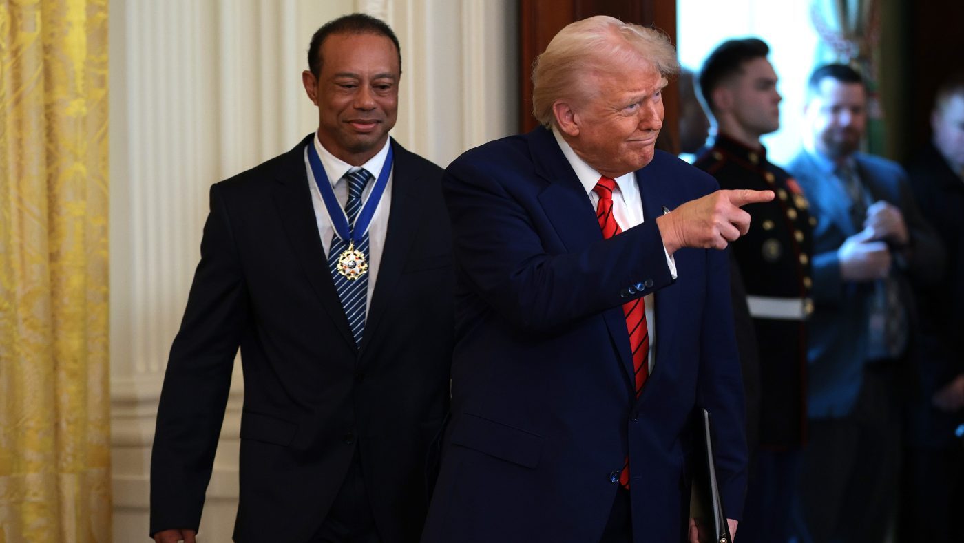 President Trump and golf legend Tiger Woods arrive for a reception honoring Black History Month in the East Room of the White House on Feb. 20, 2025, in Washington, DC.