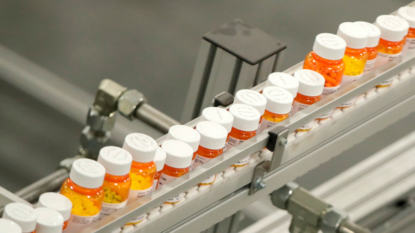 Bottles of medicine ride on a belt at a mail-in pharmacy warehouse in Florence, N.J., July 10, 2018.