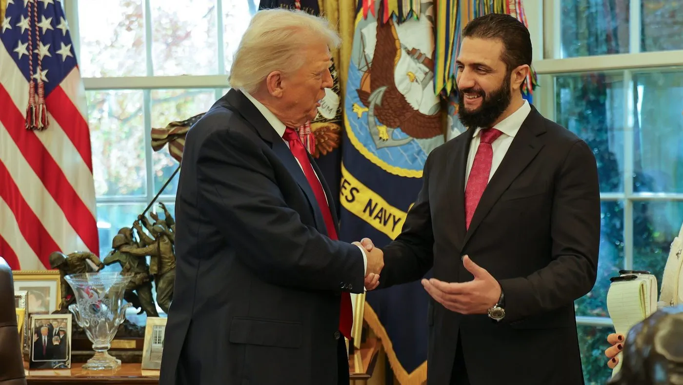 In this photo released by Syrian Presidency press office, President Donald Trump, left, shakes hands with Syria’s President Ahmad al-Sharaa, at the White House in Washington, Monday, Nov. 10, 2025. (Syrian Presidency press office via AP)