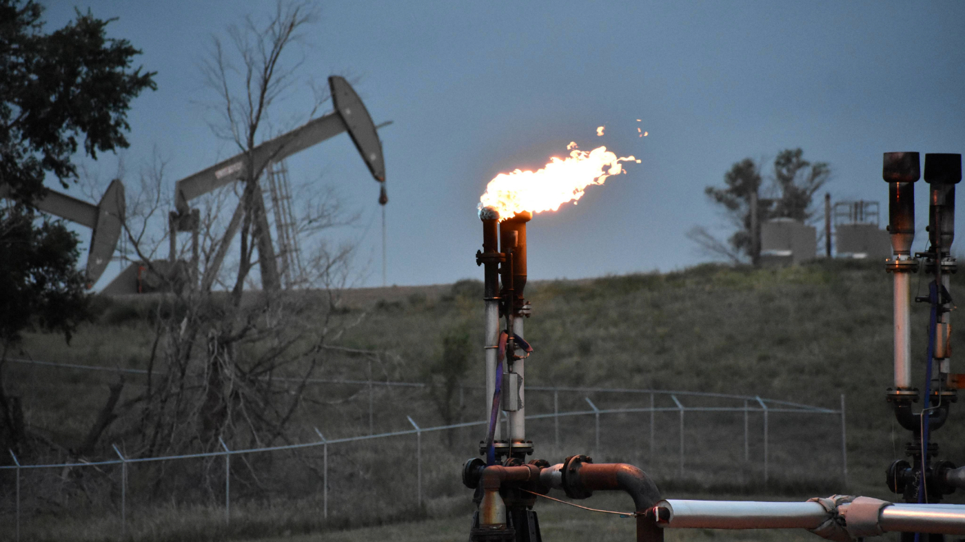 FILE – A flare to burn methane from oil production is seen on a well pad near Watford City, N.D., on Aug. 26, 2021. (AP Photo/Matthew Brown, File)