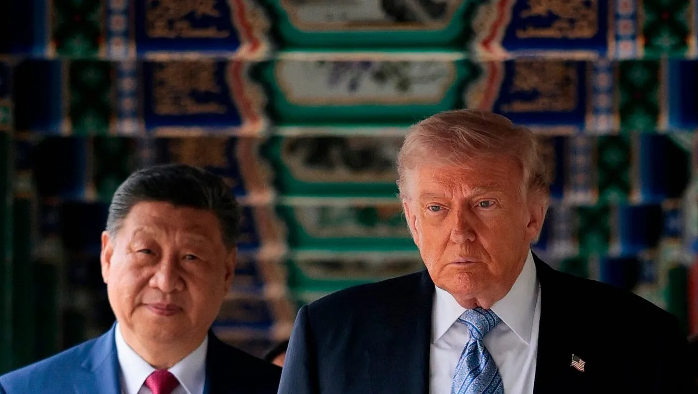 U.S. President Donald Trump, right, participates in a friendship walk through Zhongnanhai Garden with Chinese President Xi Jinping in Beijing, Friday, May 15, 2026. (Evan Vucci/Pool Photo via AP)