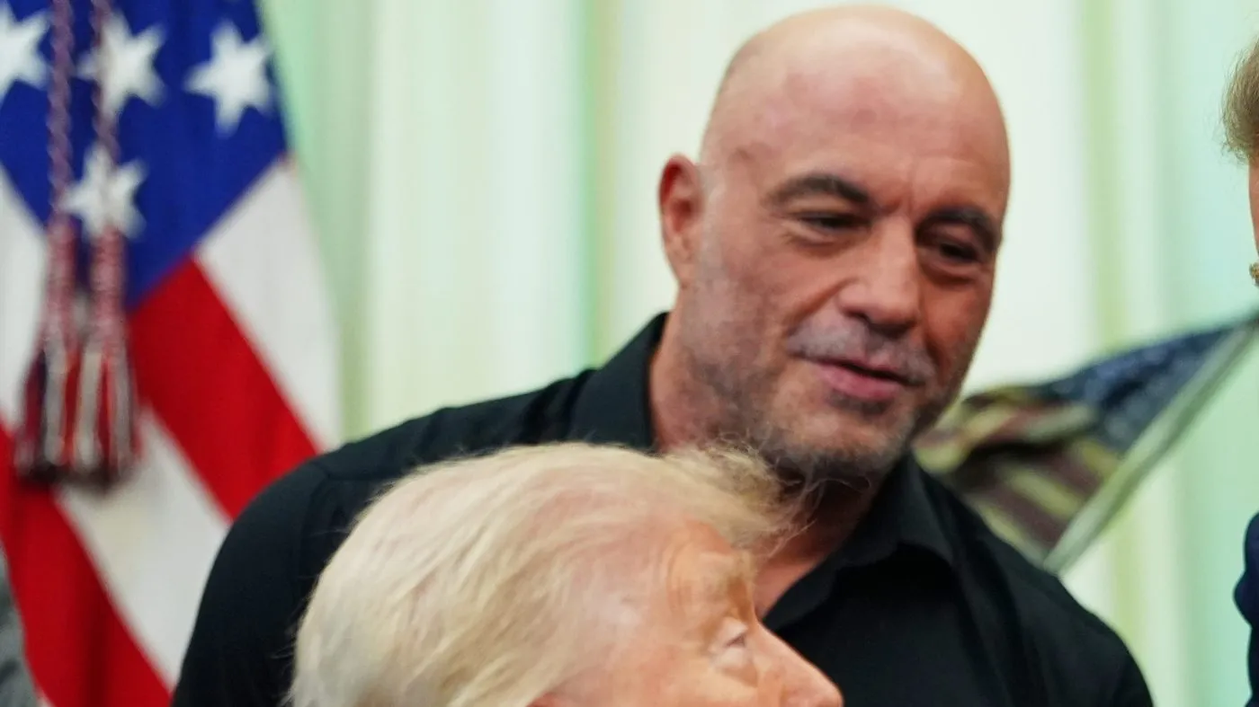 Joe Rogan listens as President Trump speaks on April 18, 2026, in the Oval Office of the White House in Washington.