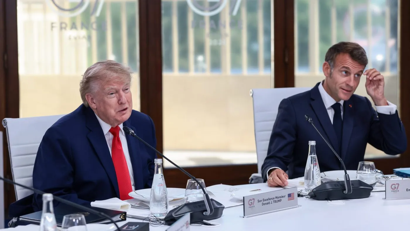 U.S. President Donald Trump, left, and French President Emmanuel Macron, right, attend a working lunch with leaders of G7 and the Middle East, in Evian-les-Bains, France, Tuesday, June 16, 2026. (Evelyn Hockstein/Pool Photo via AP)
