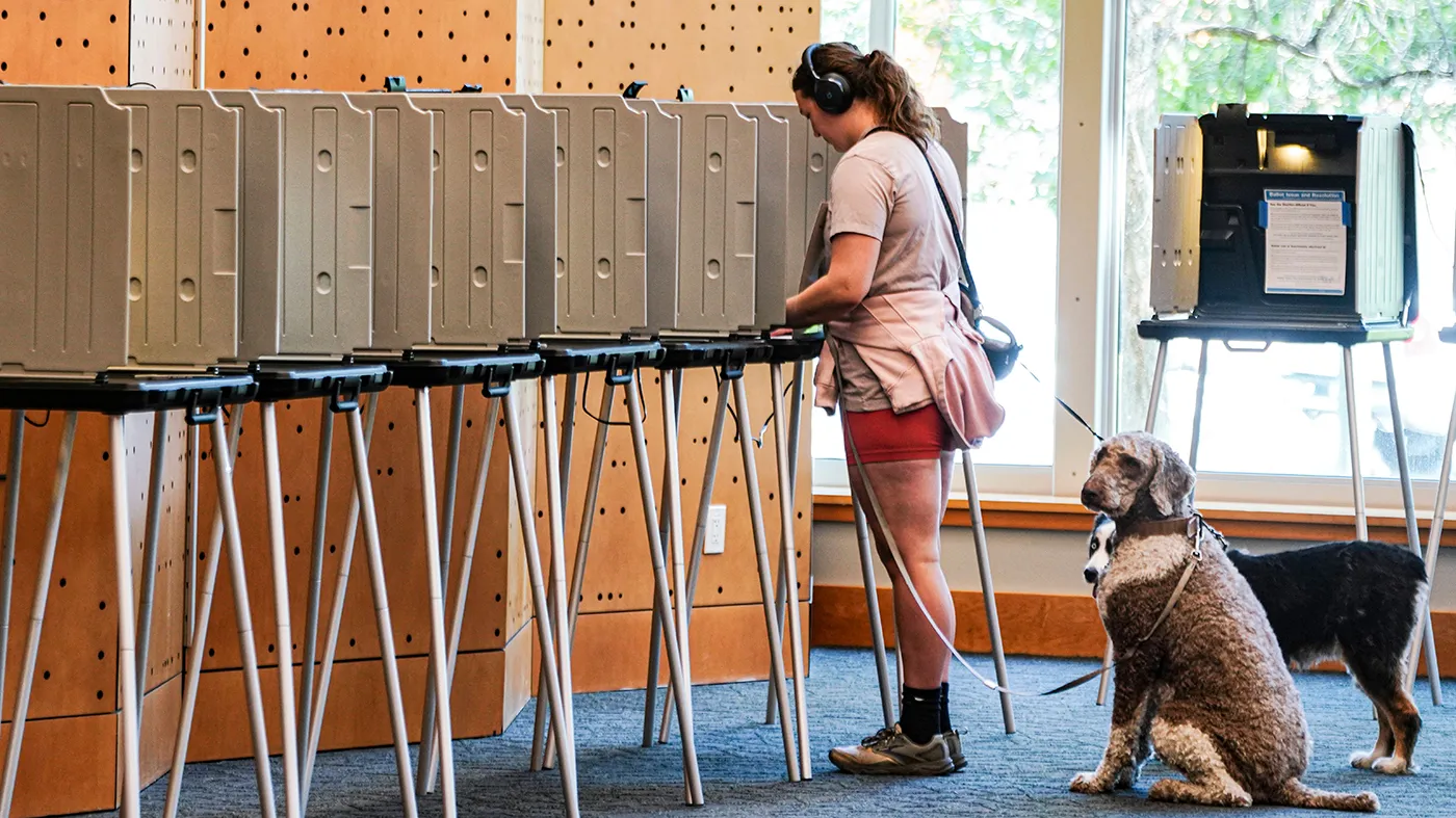 Danielle Grisolano brings her dogs Lincoln and Pepper with her to vote in the Democratic primaries at Denver Public Library, June 30, 2026, in Denver.