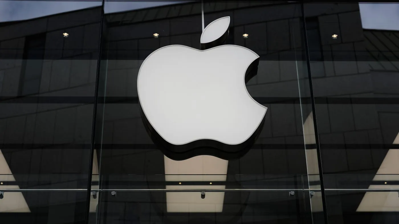 The Apple logo is illuminated at a store in Munich on April 2, 2026.