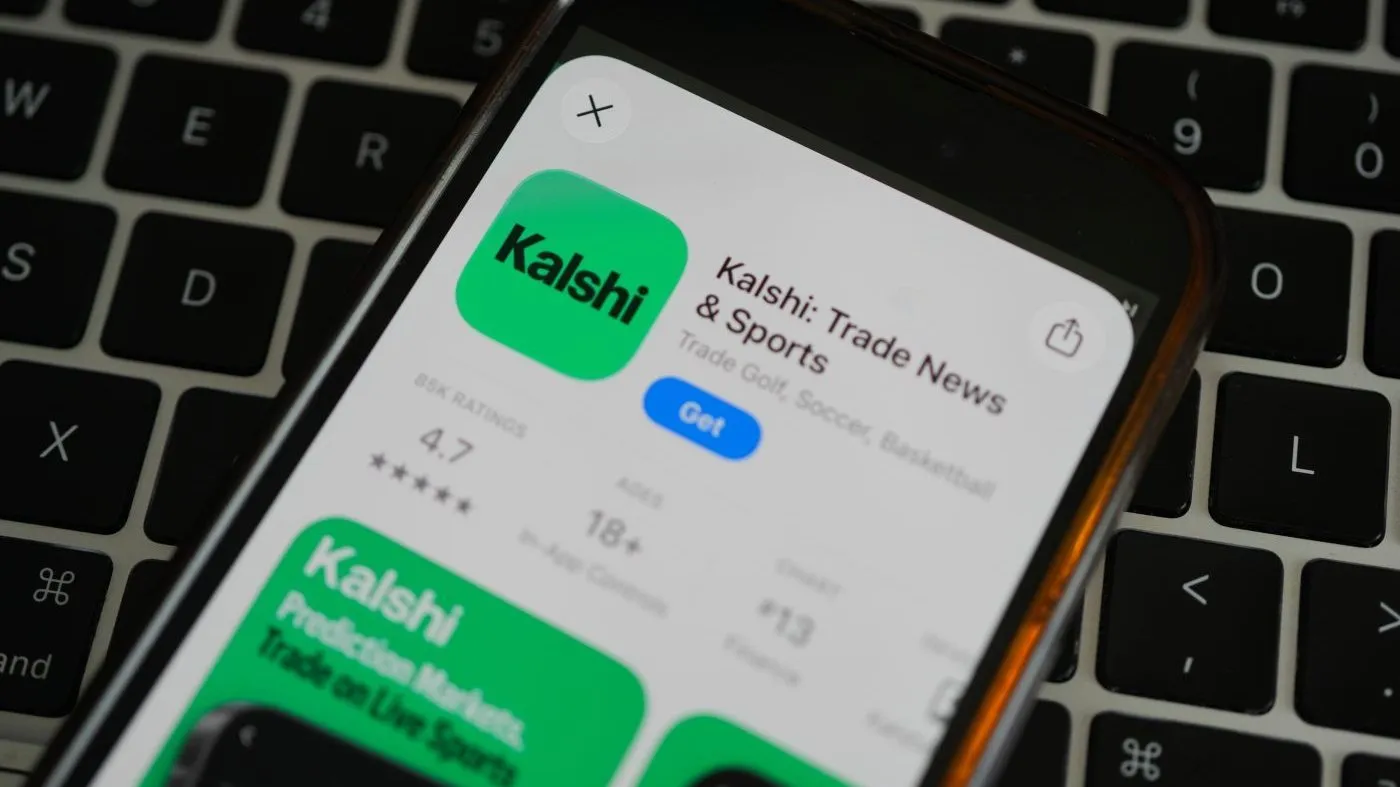 An ad for the prediction market app Kalshi is displayed on a mobile phone, April 16, 2026, in Chicago.