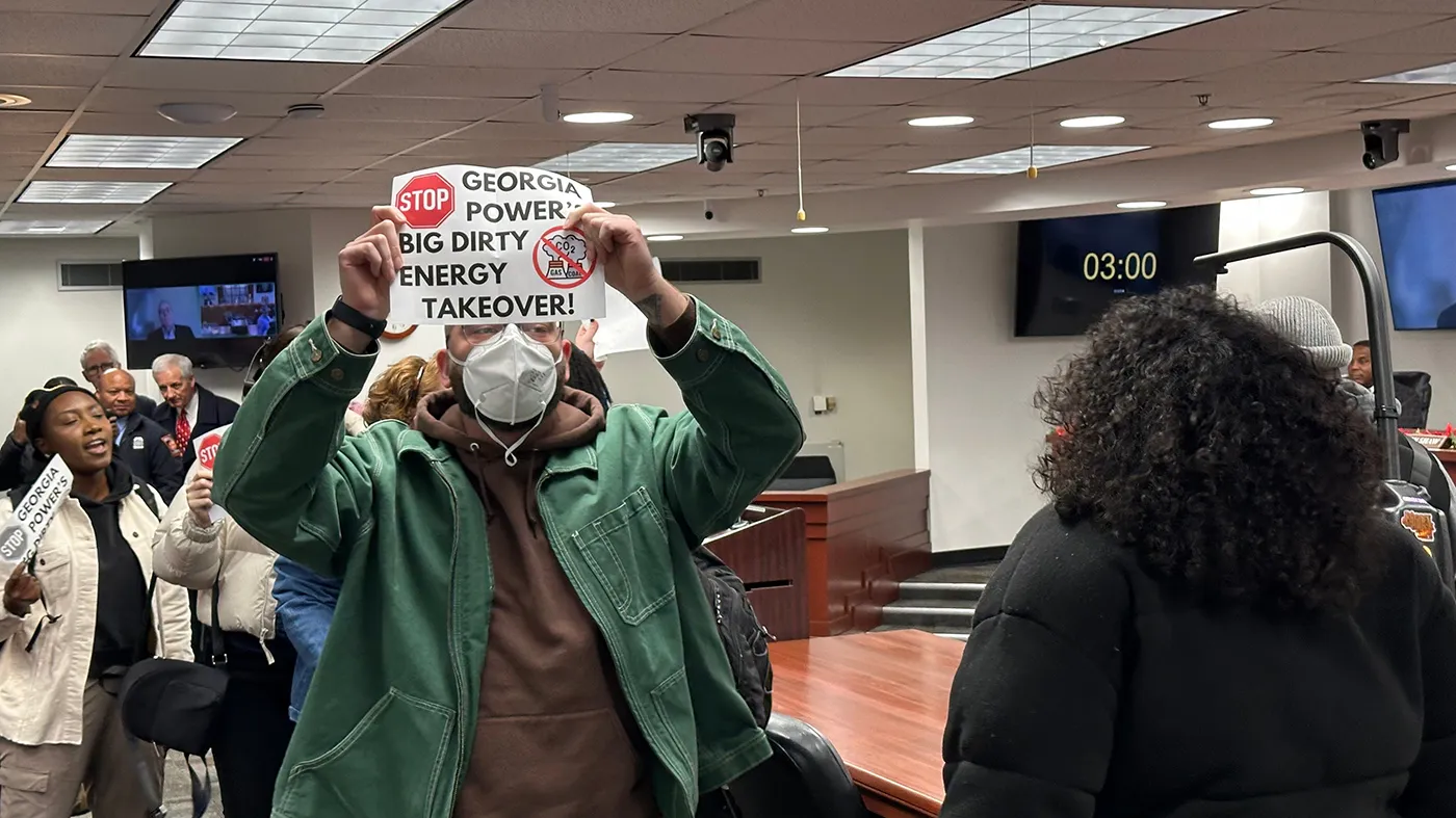 Protestors are escorted out of a Georgia Public Service Commission meeting on Dec. 19, 2025 in Atlanta.