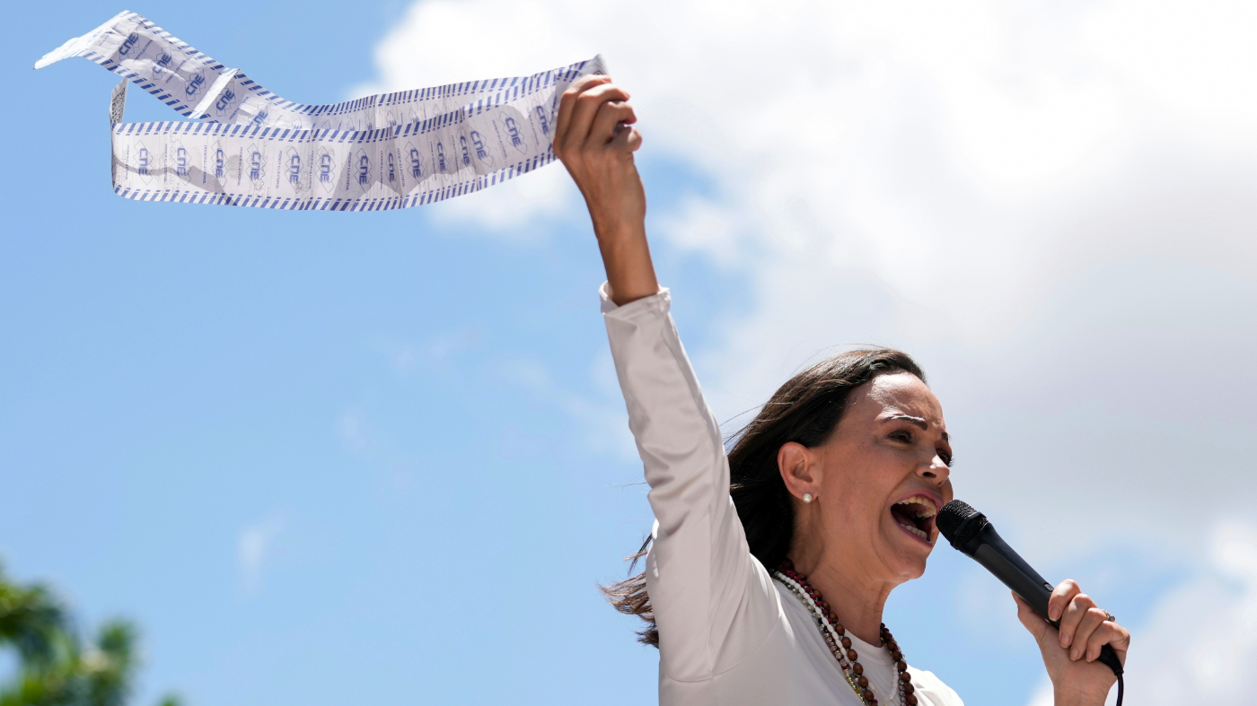 FILE – Opposition leader Maria Corina Machado displays vote tally sheets during a protest against the reelection of President Nicolas Maduro one month after the disputed presidential vote which she says the opposition won by a landslide, in Caracas, Venezuela, Wednesday, Aug. 28, 2024. (AP Photo/Ariana Cubillos, file)