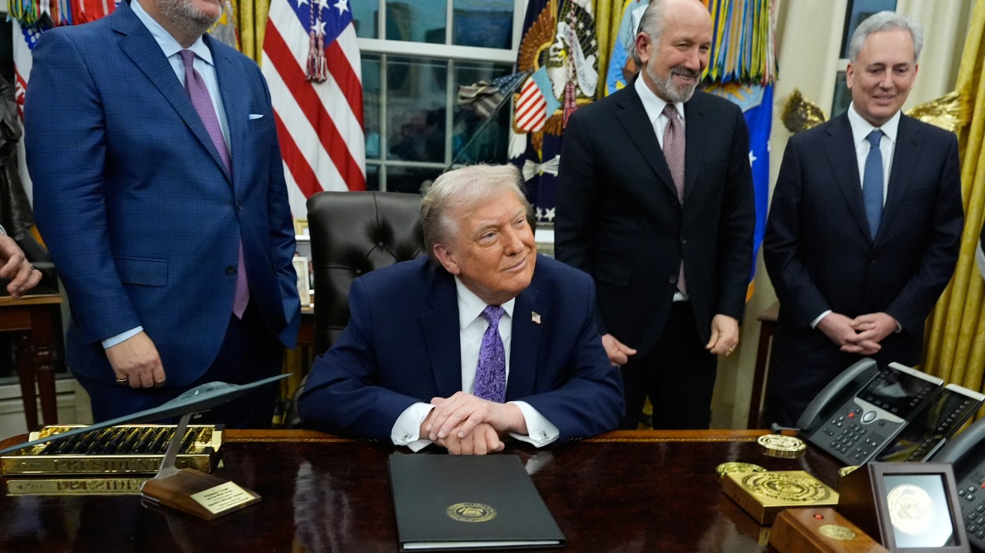 Flanked by Sen. Ted Cruz R-Texas, left, Secretary of Commerce Howard Lutnick, and White House AI and Crypto Czar David Sacks, right, President Donald Trump smiles after signing an AI initiative in the Oval Office of the White House, Thursday, Dec. 11, 2025, in Washington. (AP Photo/Alex Brandon)