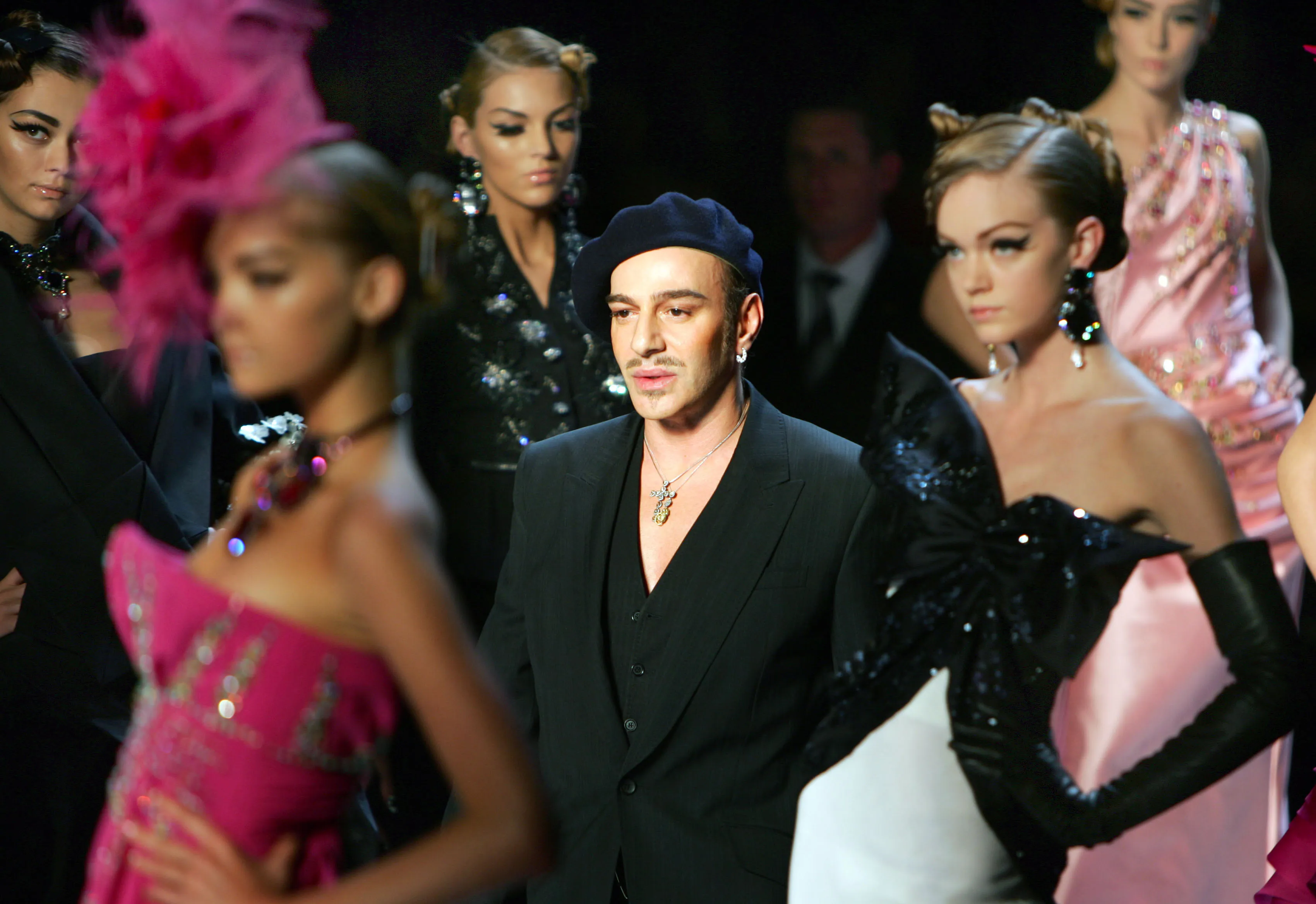 FILE – In this Feb. 27, 2007 file photo, fashion designer John Galliano, center, at the end of the presentation of the Christian Dior fall-winter 2007/2008 ready-to-wear collection in Paris. France’s Christian Dior says it is firing famed fashion designer John Galliano after an online video emerged that showed him praising Adolf Hitler. Christian Dior said Tuesday, March 1, 2011, that Galliano has been immediately laid off, just days after he was suspended as its creative director pending an investigation into an alleged anti-Semitic incident in a Paris cafe last week. (AP Photo/Remy de la Mauviniere, File)