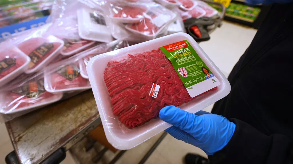 A grocery store worker prepares to display ground beef for purchase in Dallas, Wednesday, April 15, 2026. (AP Photo/LM Otero)