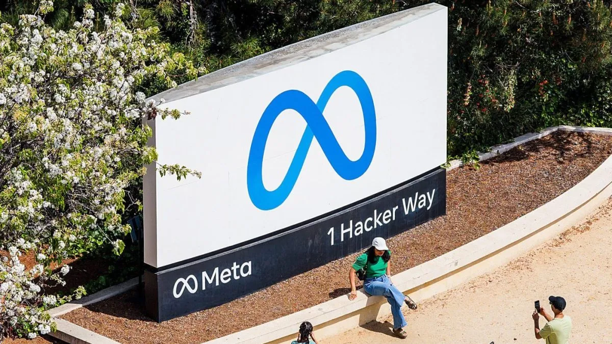 FILE – Visitors take photos at a sign outside Meta headquarters March 26, 2026, in Menlo Park, Calif. (AP Photo/Noah Berger, File)