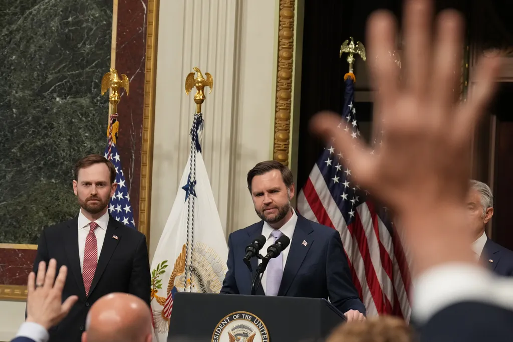 Flanked by FTC Chairman and Task Force Vice Chair Andrew Ferguson, left, and Centers for Medicare & Medicaid Services Administrator Dr. Mehmet Oz, Vice President JD Vance takes questions from the media from the Eisenhower Executive Office Building on the White House campus, Wednesday, May 13, 2026, in Washington. (AP Photo/Jacquelyn Martin)