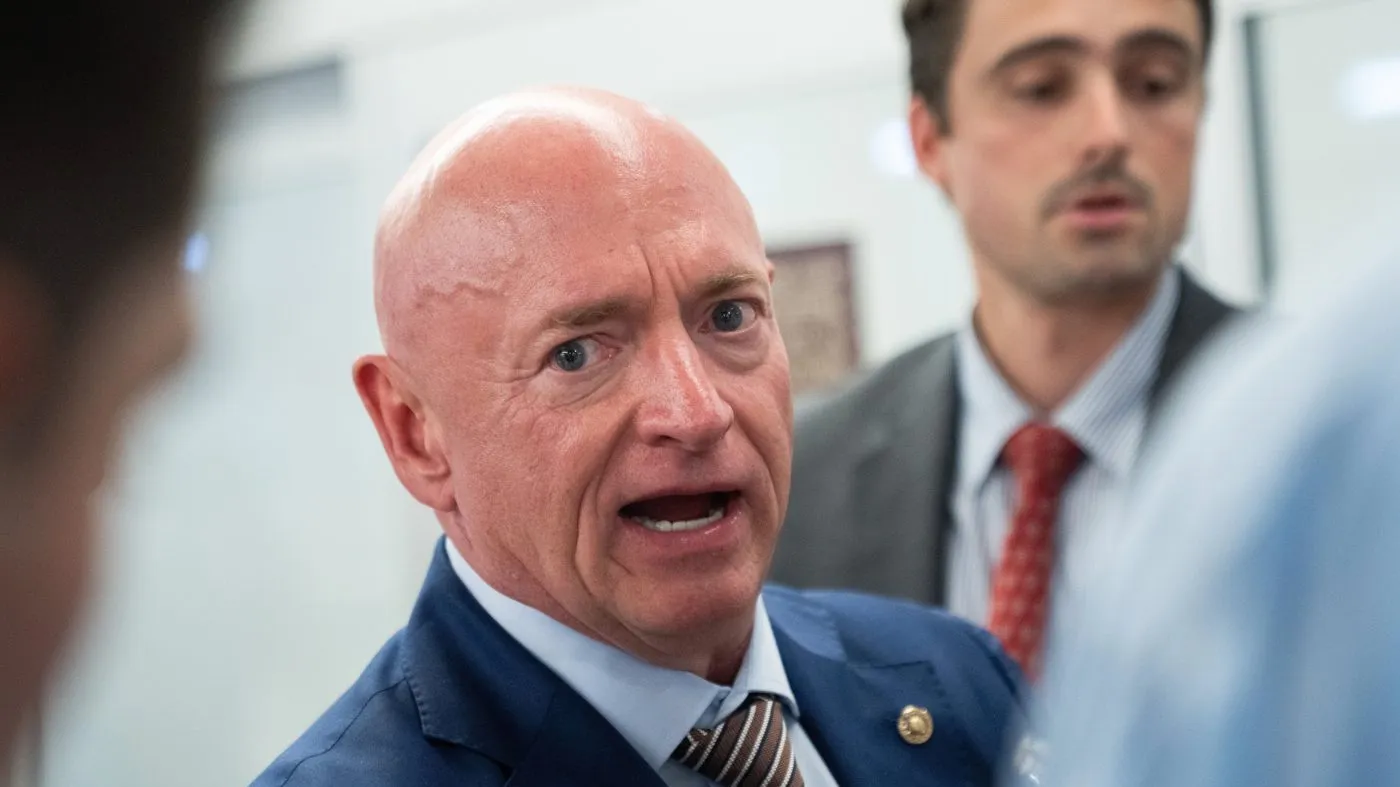 Sen. Mark Kelly (D-Ariz.) talks with reporters at the Capitol during votes in Washington, July 16, 2026.
