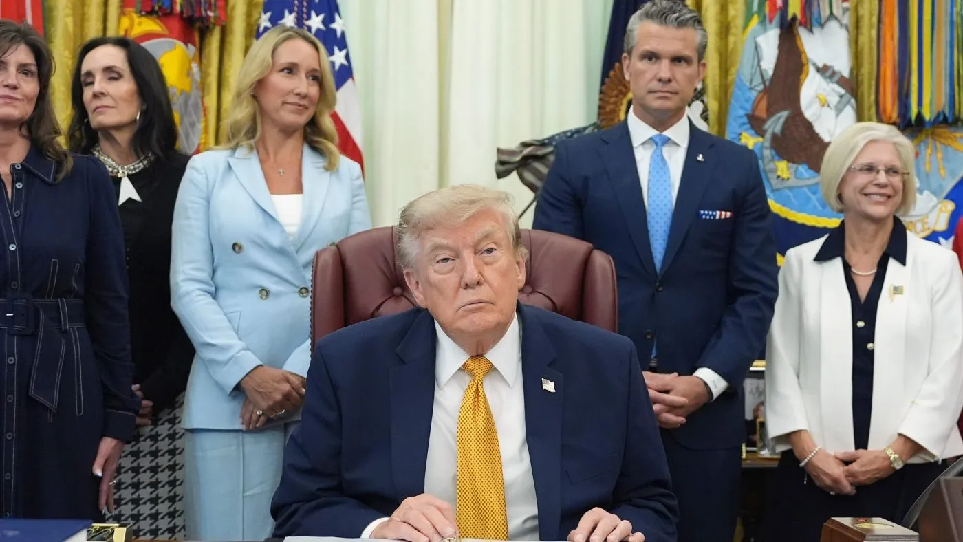 President Trump speaks alongside Jennifer Rauchet, center left, and Defense Secretary Pete Hegseth, center right, during a meeting about military families, in the Oval Office of the White House, Aug. 3, 2026, in Washington.