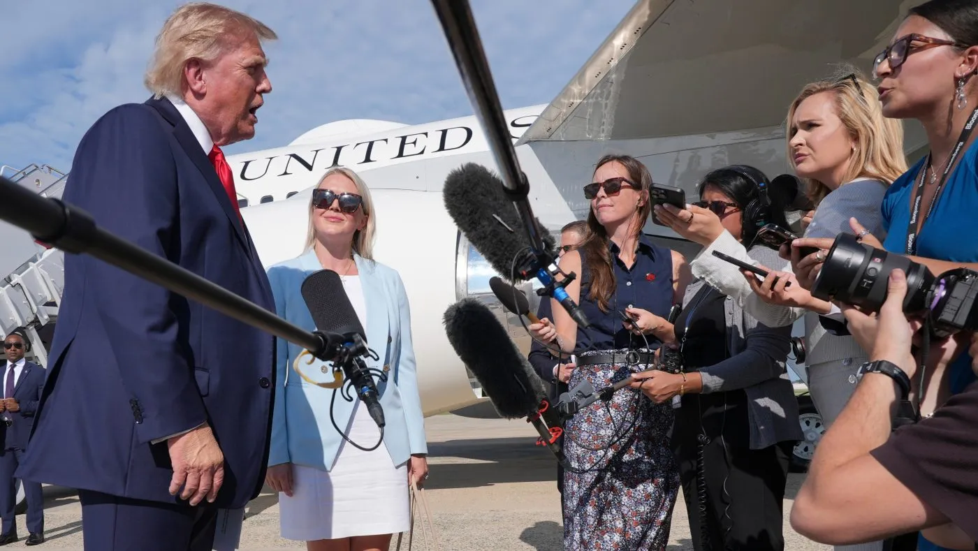 President Trump, from left, speaks with reporters as White House press secretary Karoline Leavitt listens, before boarding Air Force One, Aug. 21, 2026, at Joint Base Andrews, Md., en route to South Carolina.