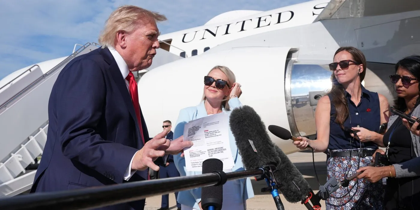 President Trump, from left, speaks with reporters as White House press secretary Karoline Leavitt listens, before boarding Air Force One, Aug. 21, 2026, at Joint Base Andrews, Md., en route to South Carolina.