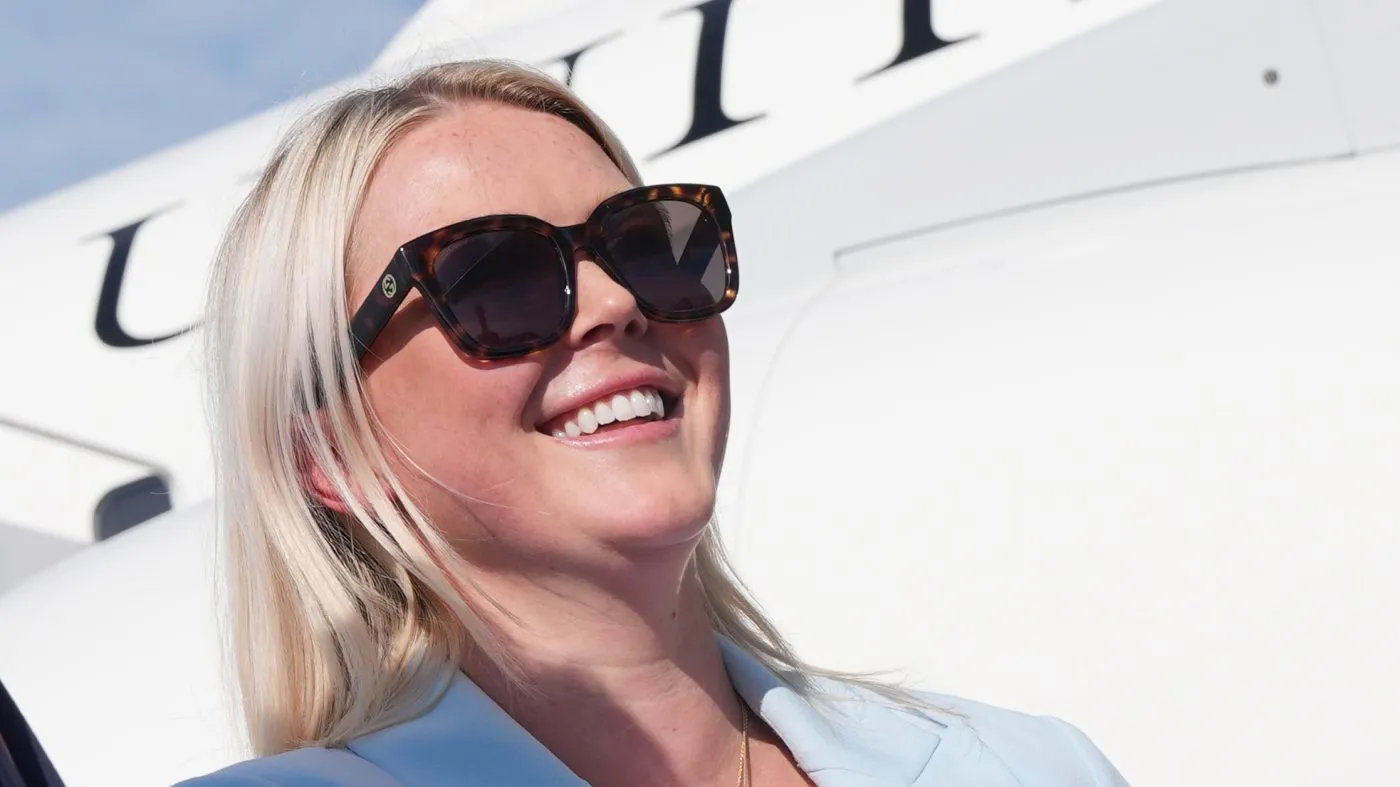 White House press secretary Karoline Leavitt listens as President Donald Trump speaks to reporters before boarding Air Force One, Friday, Aug. 21, 2026, at Joint Base Andrews, Md., en route to South Carolina. (AP Photo/Jacquelyn Martin)