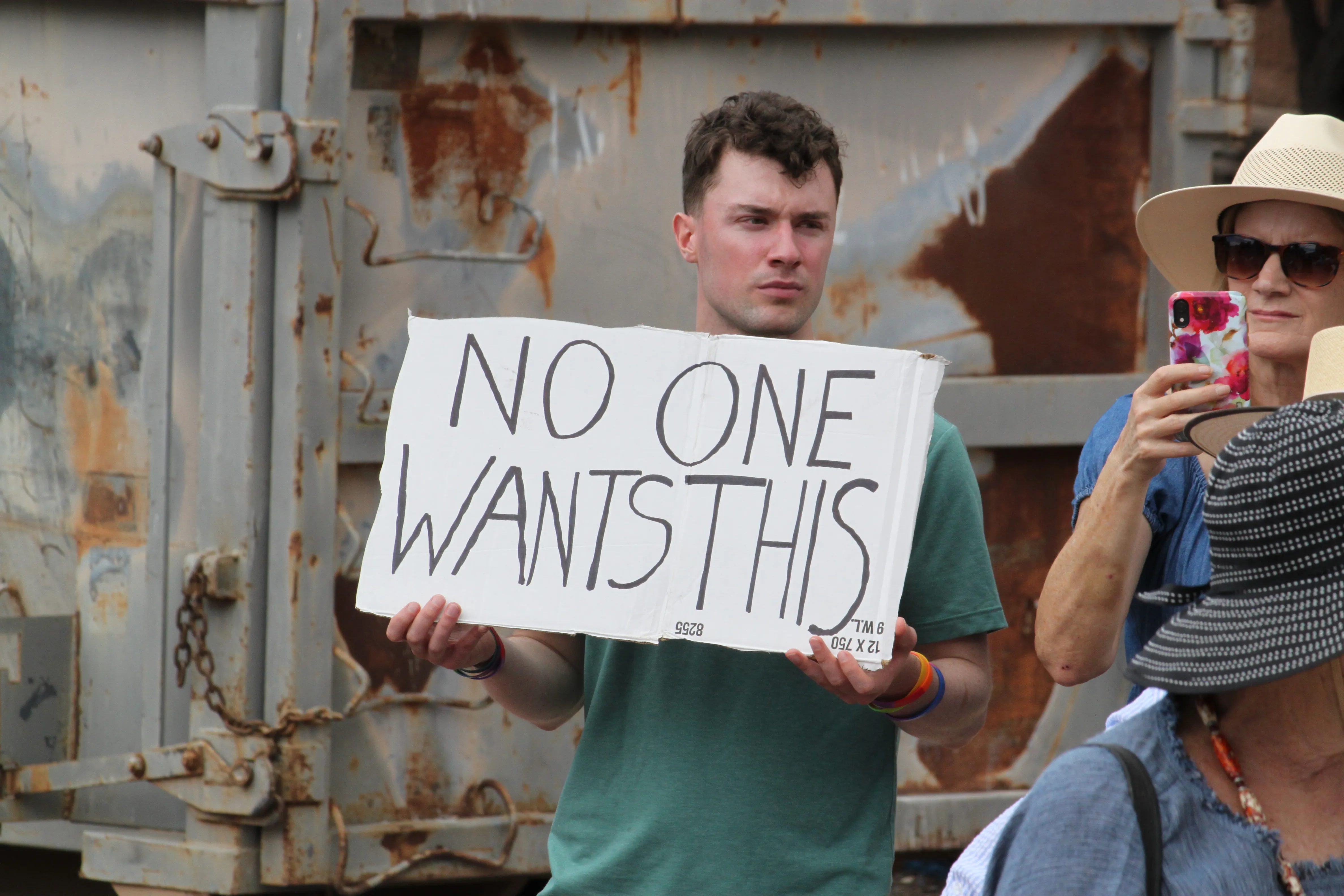 Jacob Weinreich holds a sign in opposition to the Project Jupiter data center during a demonstration outside a state office in Santa Fe, N.M., Friday, Aug. 21, 2026. (AP Photo/Susan Montoya Bryan)