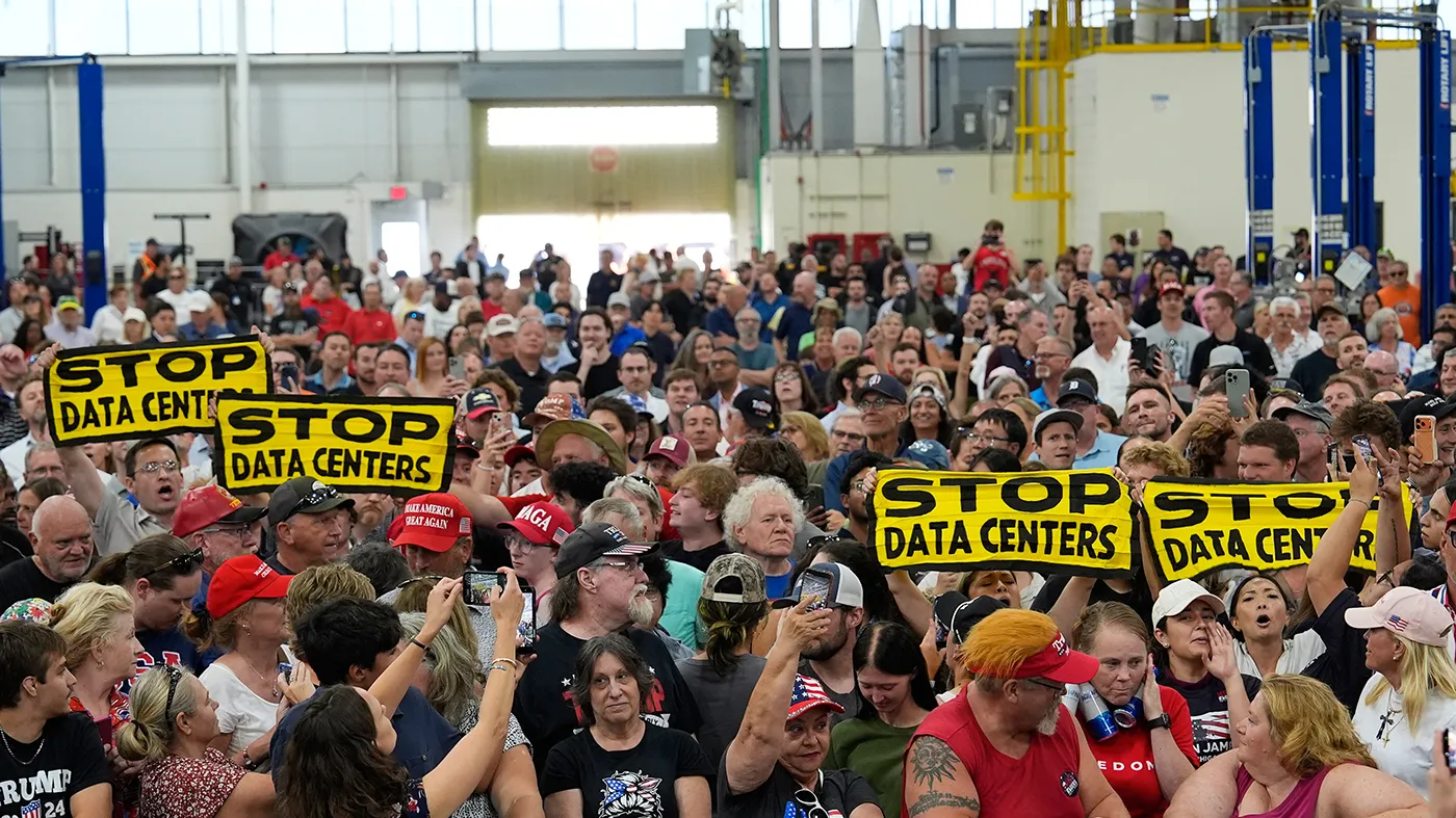 People wait for President Trump to arrive at an event at the General Motors Proving Ground on July 27, 2026, in Milford, Mich.