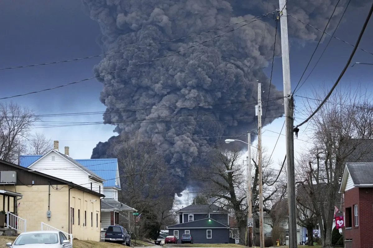 A black plume rises over East Palestine, Ohio, as a result of a controlled detonation of a portion of the derailed Norfolk Southern trains, Feb. 6, 2023. (AP Photo/Gene J. Puskar, file)