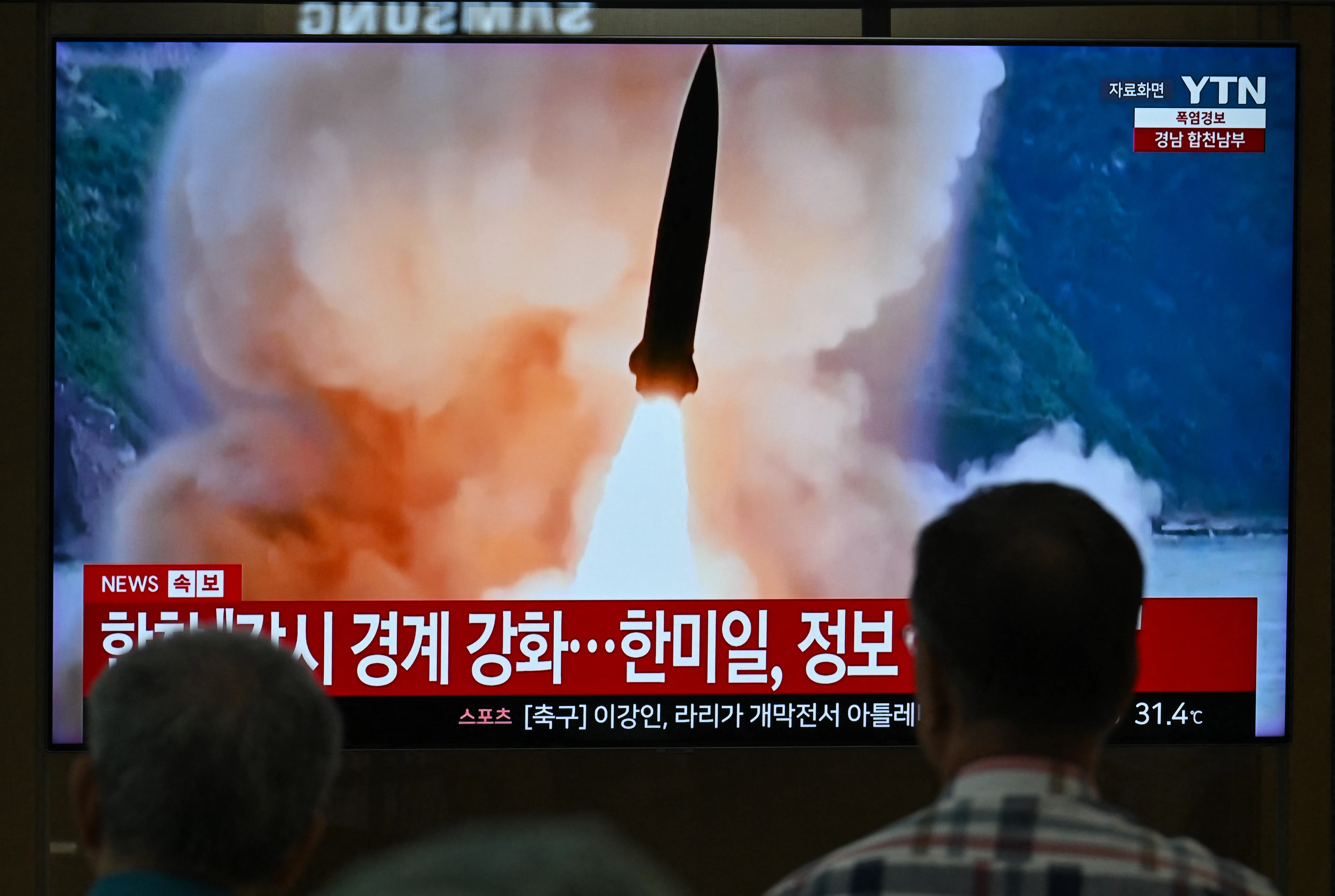 People watch a television screen showing a news broadcast with file footage of a North Korean missile test, at a train station in Seoul on August 20, 2026. North Korea fired around 10 short-range ballistic missiles, South Korea’s military said on August 20, hours after US President Donald Trump said he would meet Pyongyang’s leader Kim Jong Un later this year. (Photo by Jung Yeon-je / AFP via Getty Images)