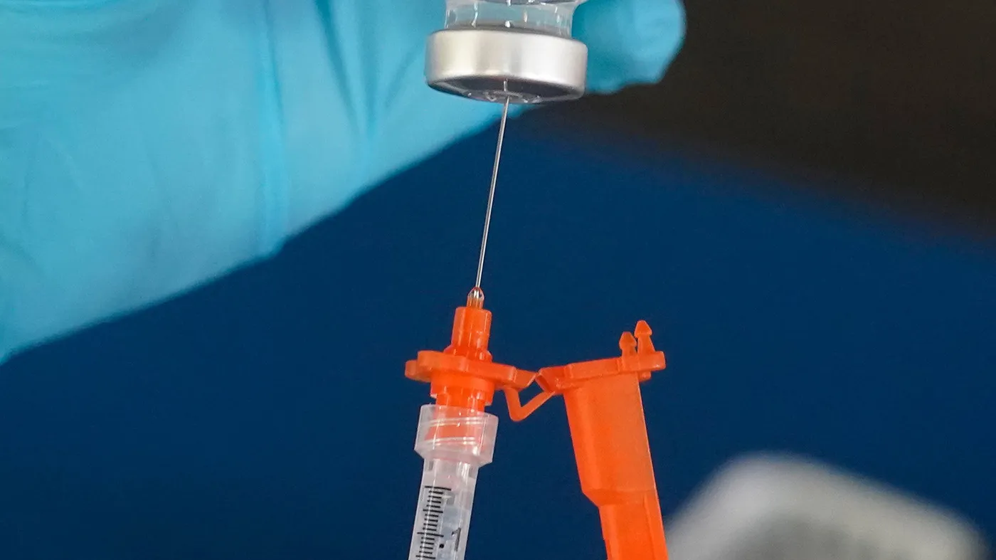 A nurse loads a syringe with a COVID-19 booster vaccine at an inoculation station in Jackson, Miss., Nov. 18, 2022. (Rogelio V. Solis, Associated Press file)