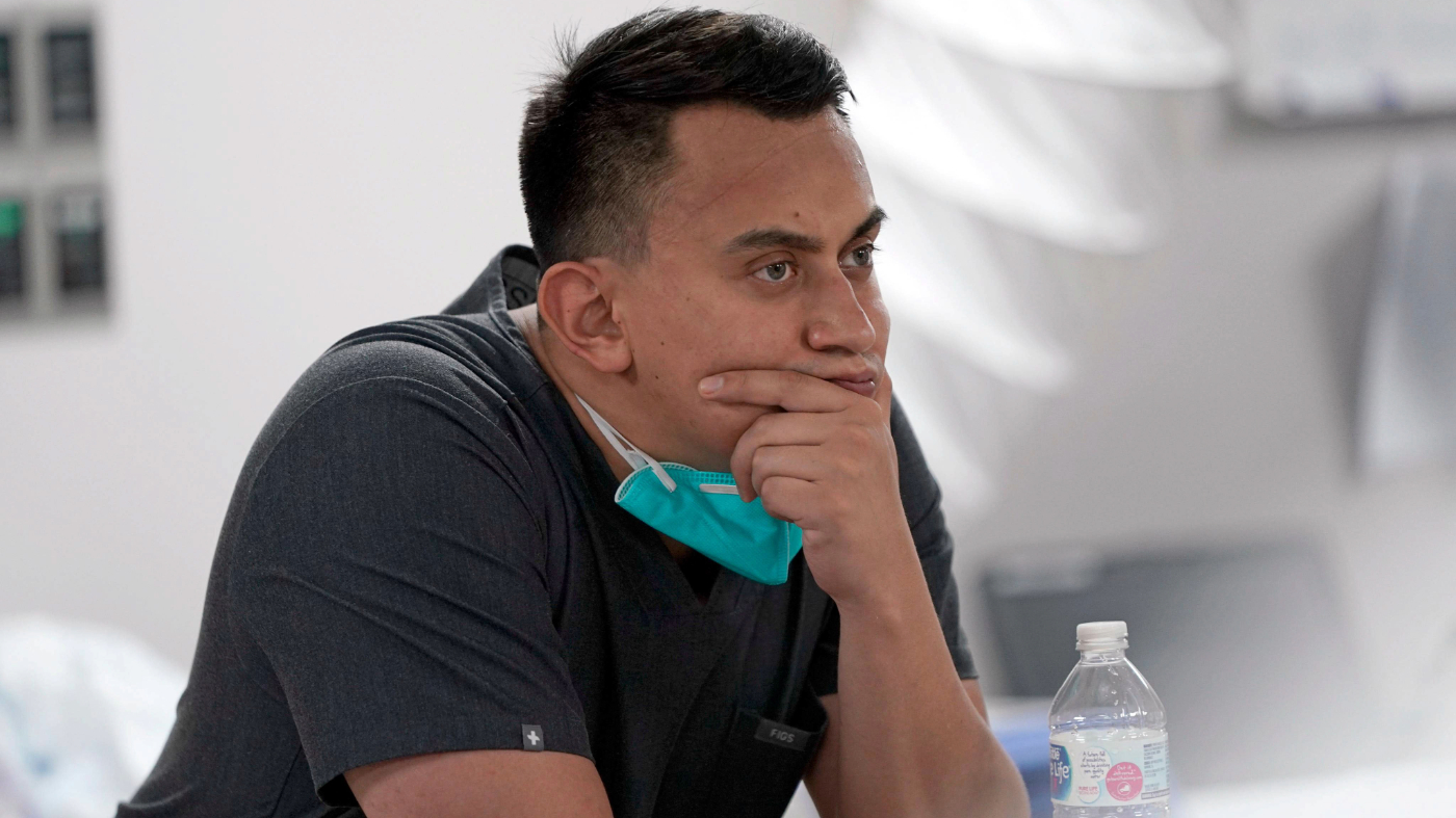 Medical student Diego Montelongo pauses after a patient died inside the Coronavirus Unit at United Memorial Medical Center, Monday, July 6, 2020, in Houston. (AP Photo/David J. Phillip)