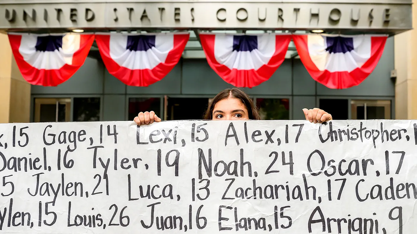 Olivia Konar holds a banner with names of young people who advocates say died as a result of social media outside the Ronald V. Dellums Federal Building and U.S. Courthouse on Aug. 18, 2026, in Oakland, Calif. Her sister Coco Konar died in 2022 when she was 17.