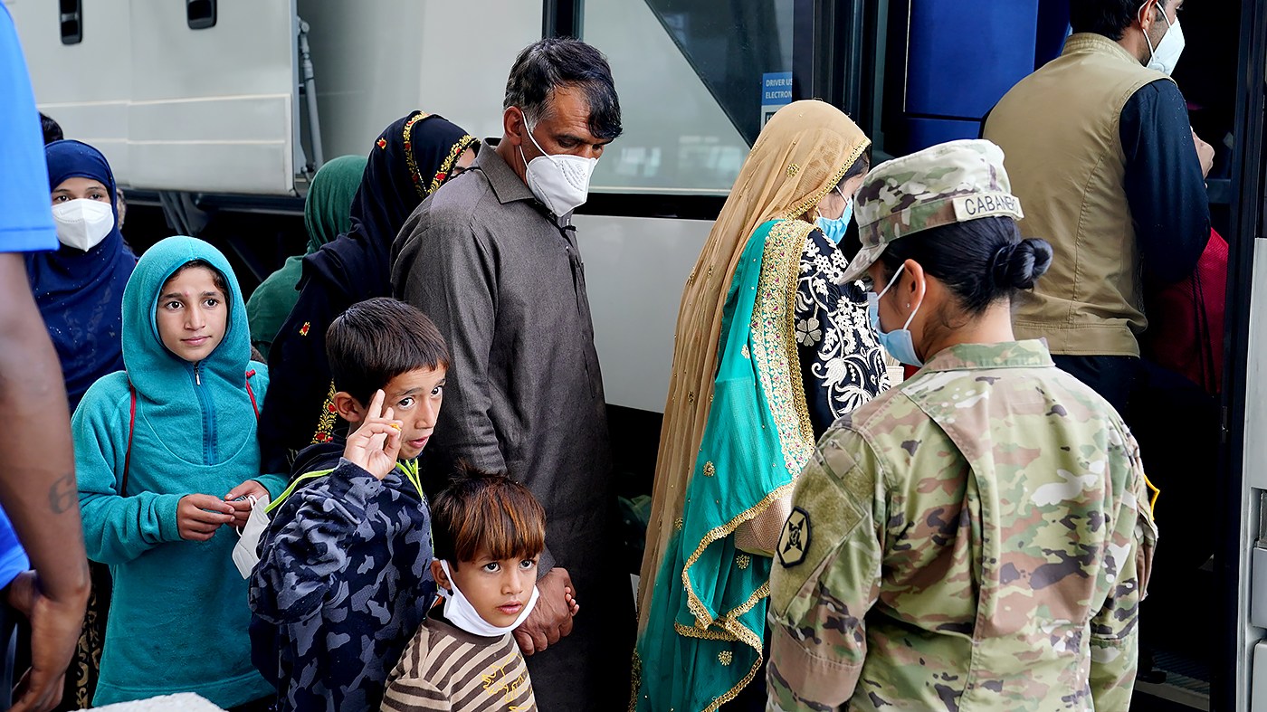 Afghan refugees displaced from their homes due to the Taliban takeover arrive at Washington Dulles International Airport in Chantilly, Va., on August 30, 2021.