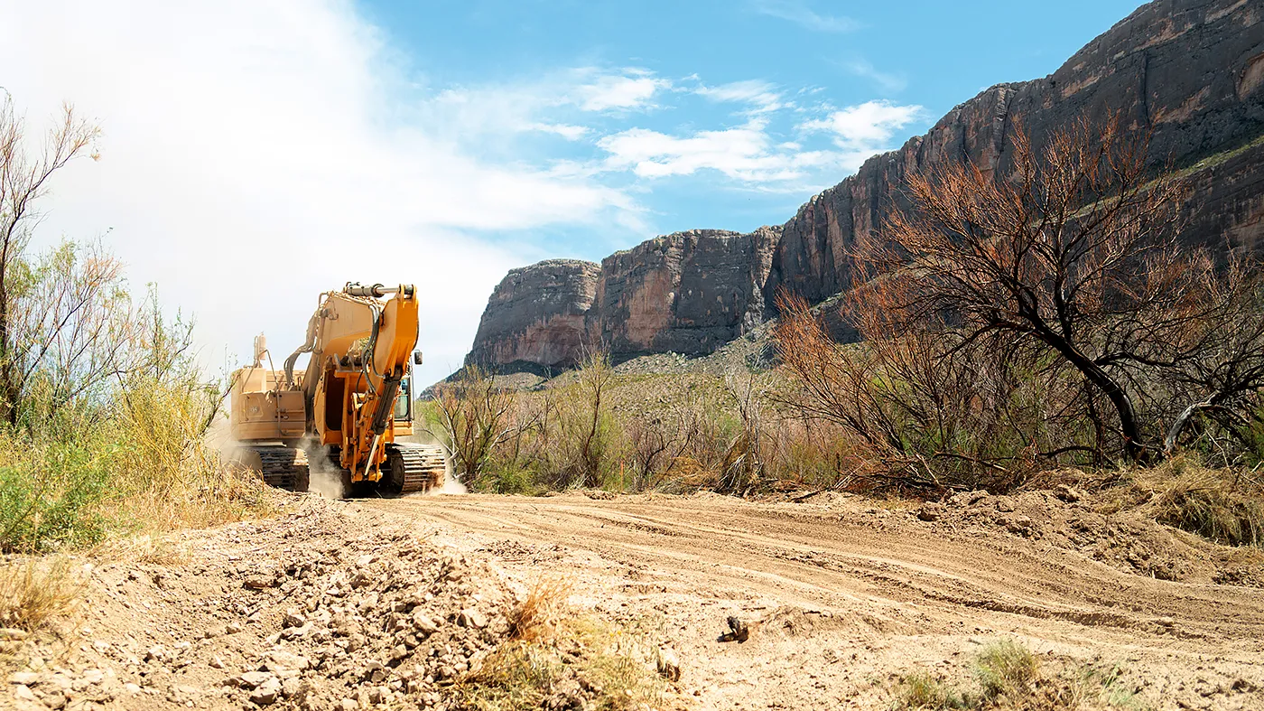 An excavator plows through land during construction for a section of border wall near Santa Elena Canyon on August 14, 2026 in Big Bend National Park, Texas.