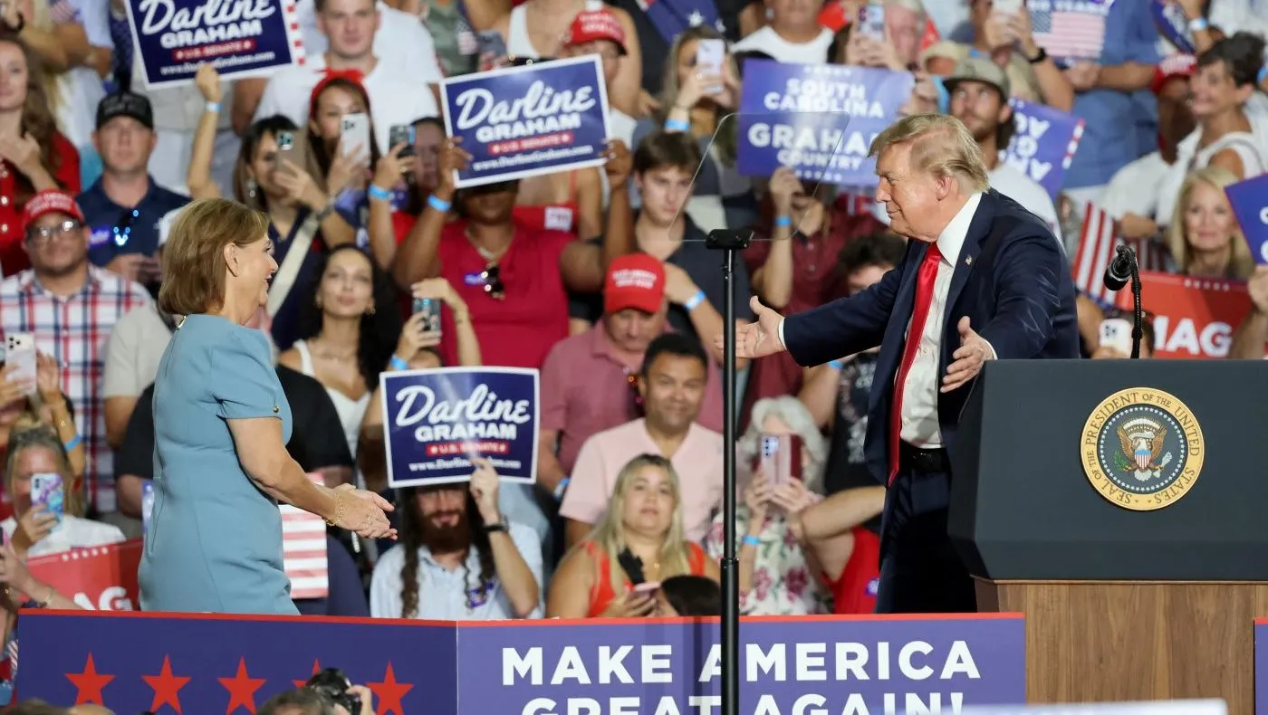 President Donald Trump brings up Sen. Darline Graham, R-S.C., during her campaign event at the Myrtle Beach Convention Center in Myrtle Beach, S.C., Friday, Aug. 21, 2026. (AP Photo/Mic Smith)