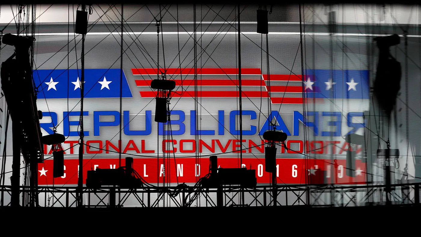 A Republican National Convention logo is seen though silhouetted production equipment on a huge video screen at Quicken Loans Arena for the Republican National Convention, July 17, 2016, in Cleveland.