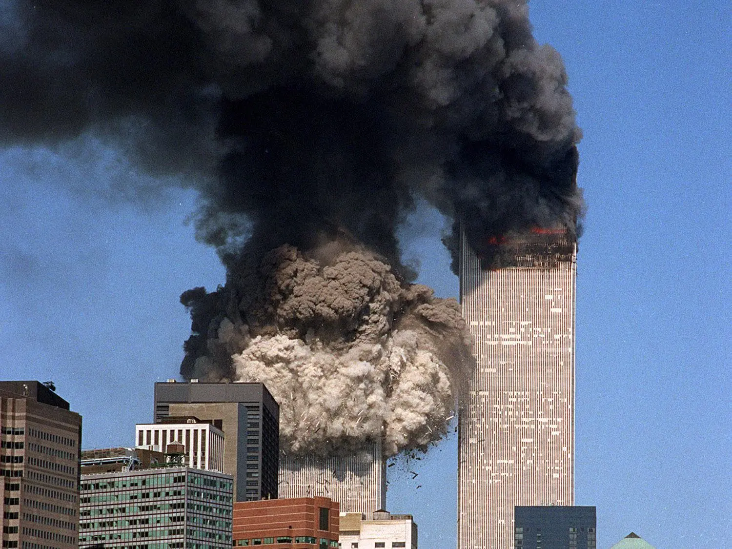 South tower of World Trade Center collapses (l) after terrorist attack, New York City, photo