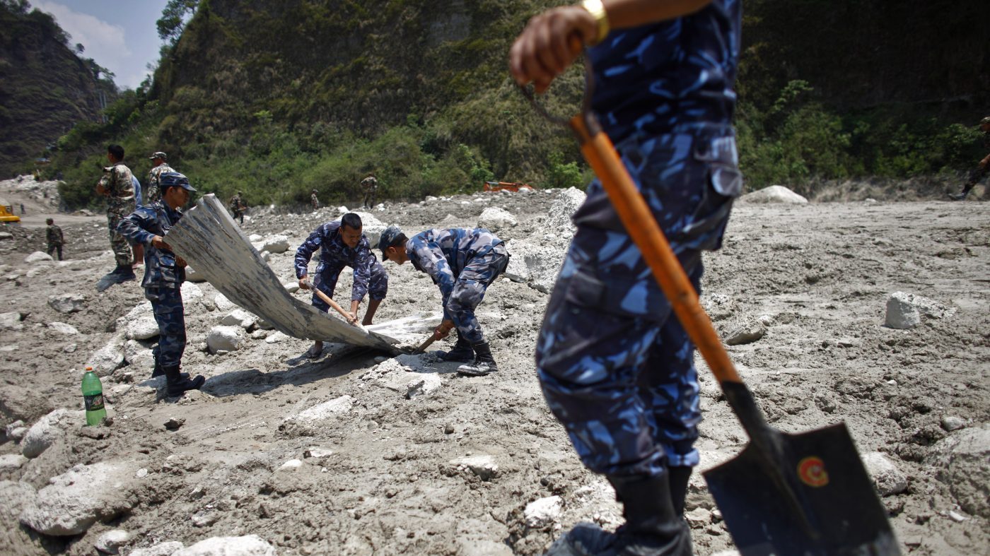 Nepalese rescuers search through mud and debris after a flash flood in the Seti river at Kharapani village of Kaski district, about 200 kilometers (125 miles) west of capital Katmandu, Nepal, May 7, 2012.