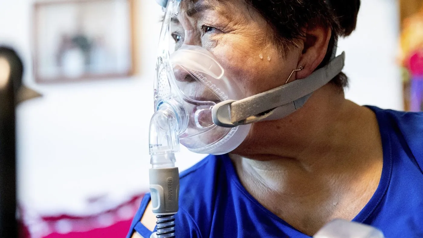 Environmental activist Maria Arevalo, 74, demonstrates the air machine she uses to treat sleep apnea on Monday, May 20, 2024, in Pixley, Calif. Arevalo said she believes her asthma and sleep apnea are linked to pollution from numerous dairies near her home. (AP Photo/Noah Berger)