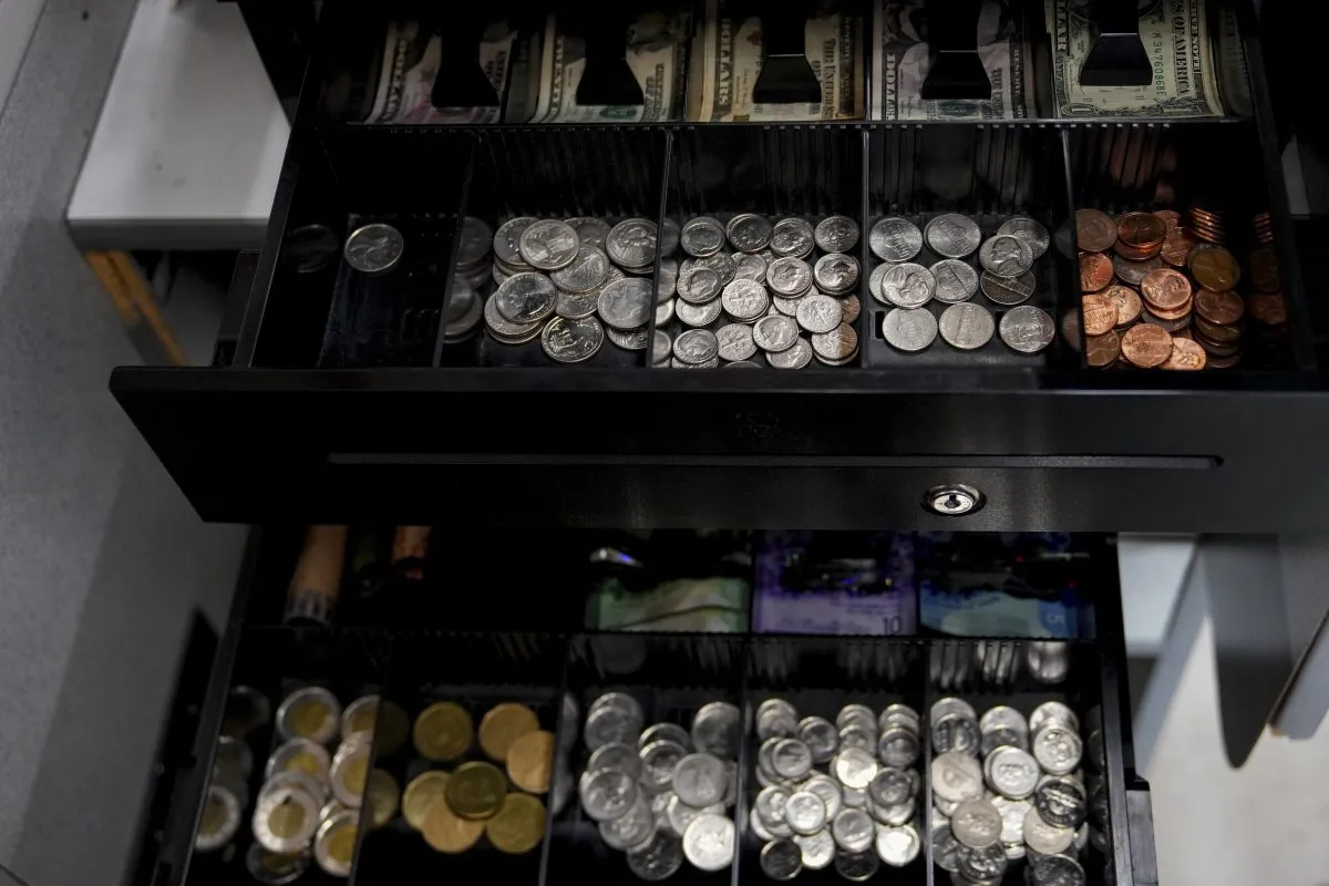 A cash register at the Point Roberts International Marketplace has two trays for both Canadian and U.S. currencies, Tuesday, March 18, 2025, in Point Roberts, Wash. (AP Photo/Lindsey Wasson)