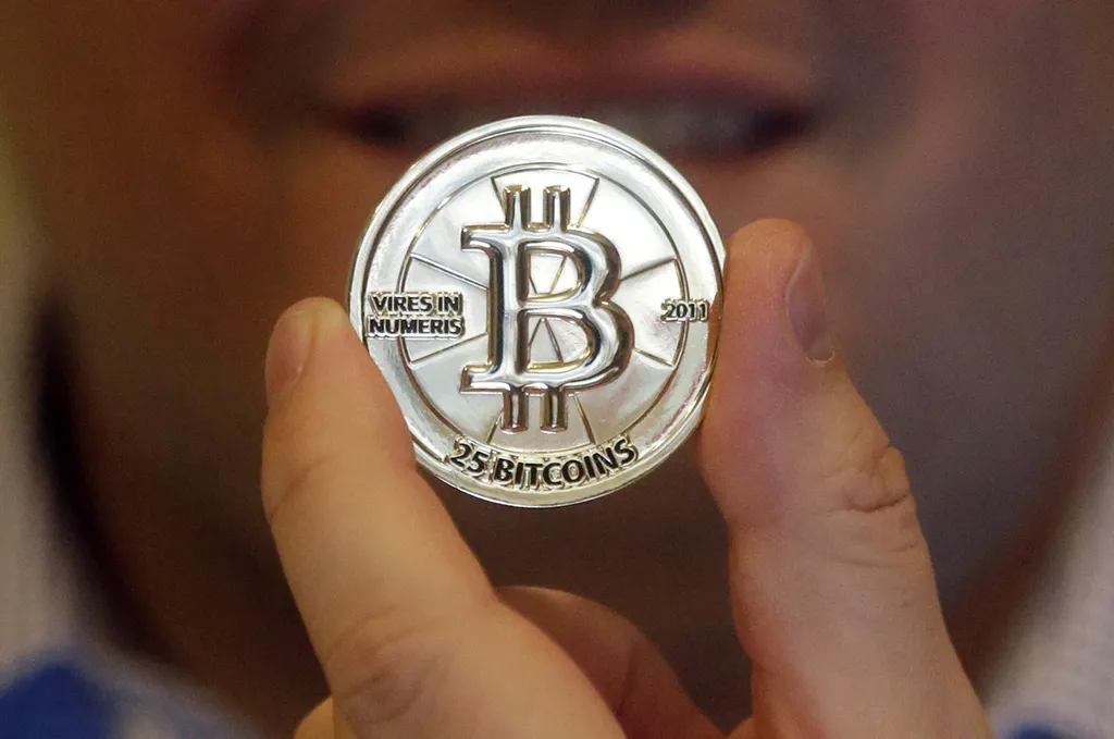 FILE – In this April 3, 2013 photo, a 25 Bitcoin token is displayed in Sandy, Utah. (AP Photo/Rick Bowmer, File)
