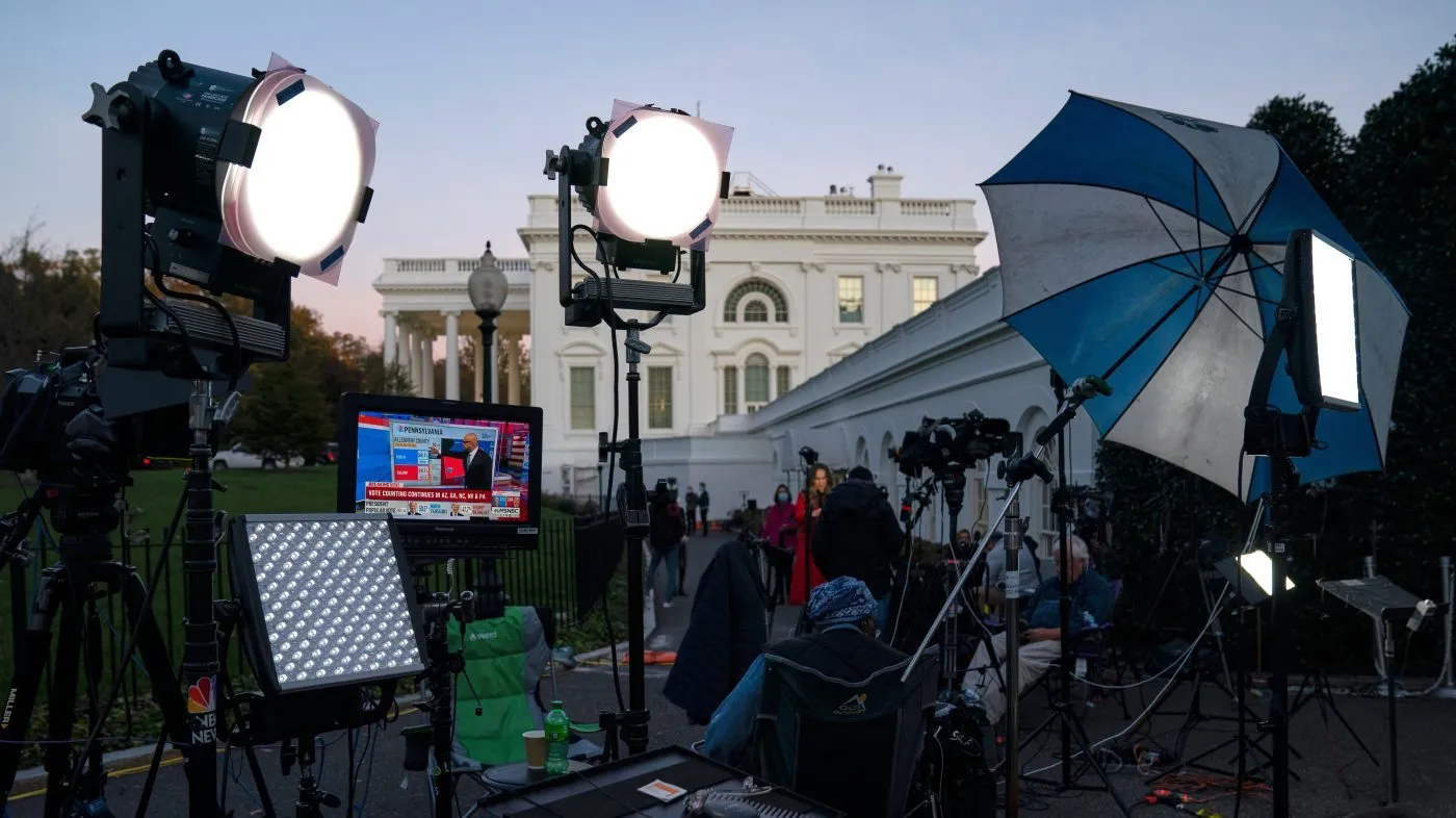 FILE – A feed from the MSNBC cable news channel is pictured on a monitor as media organizations set up outside the White House, Nov. 6, 2020, in Washington.
