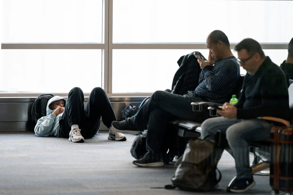 Passengers wait for a flight at Ronald Reagan National Airport, in Arlington, Va., Monday, March 16, 2026. (AP Photo/Cliff Owen)