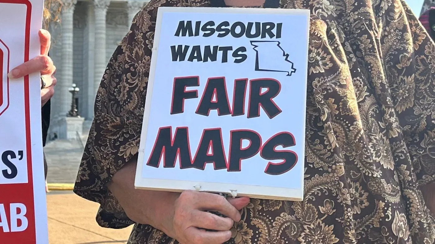 Missourians hold signs protesting new U.S. House districts passed by the state Legislature during a rally on March 10, 2026, outside the state Capitol in Jefferson City, Mo. (AP Photo/David A. Lieb)