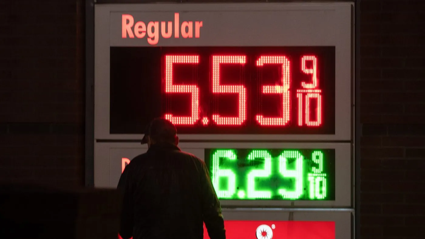 A person walks past a sign for fuel prices at a gas station on May 6, 2026, in Portland, Ore.
